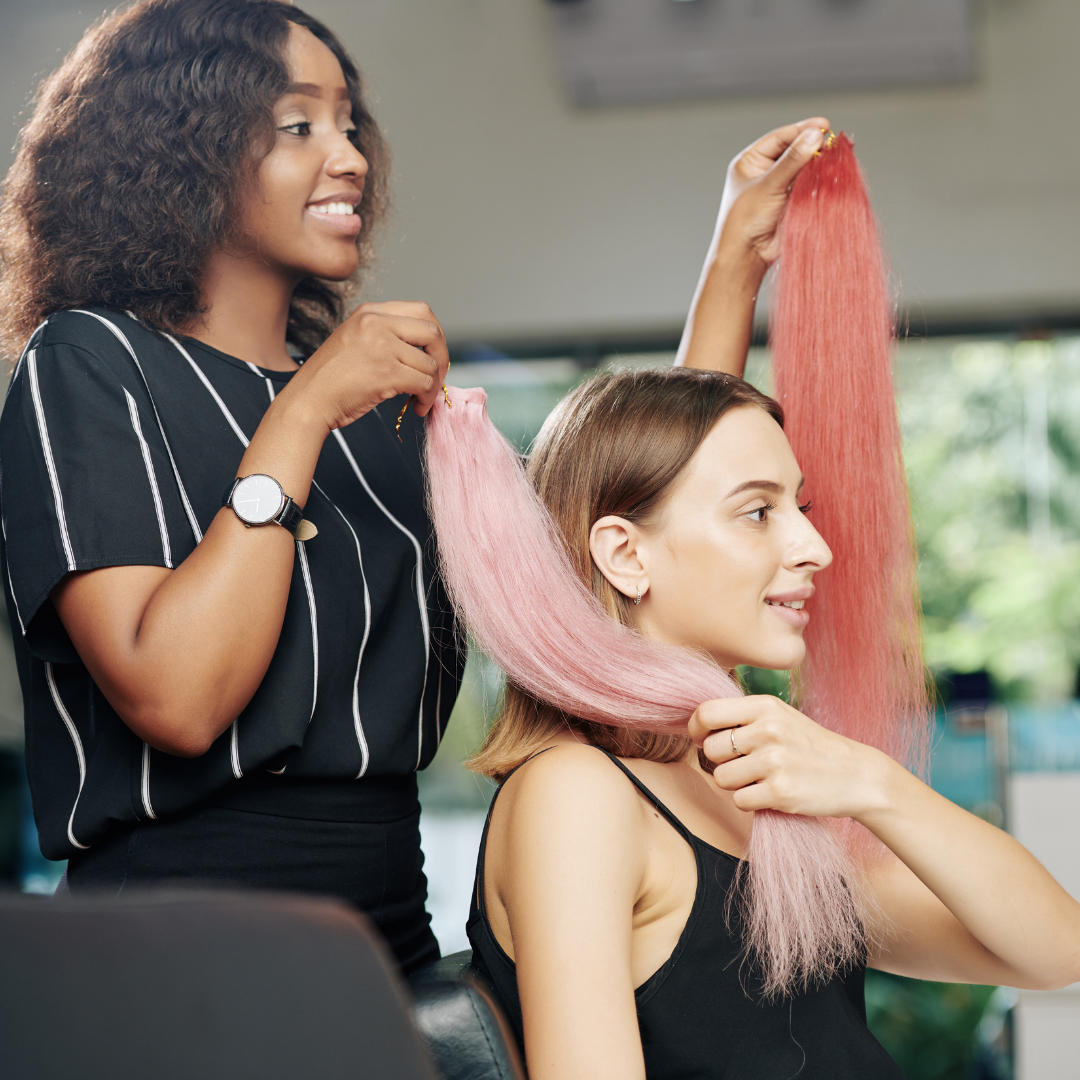 two women choosing pink and red hair extensions